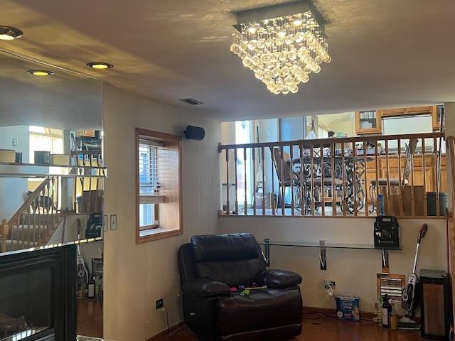 sitting room with a chandelier and visible vents