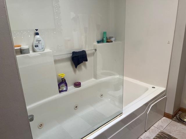 full bath featuring a whirlpool tub and tile patterned floors