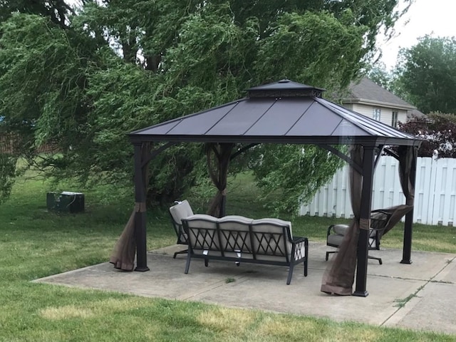 view of community featuring a patio, an outdoor hangout area, fence, a gazebo, and a lawn