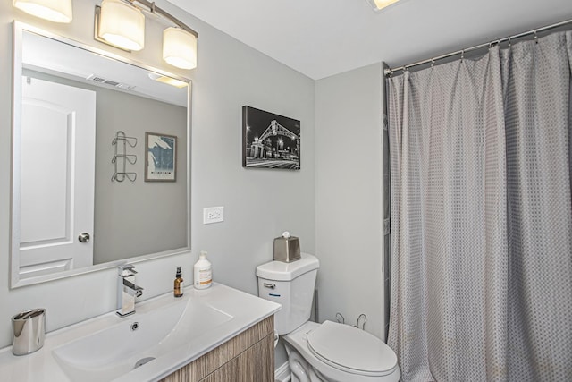 bathroom with toilet, vanity, visible vents, and a shower with curtain