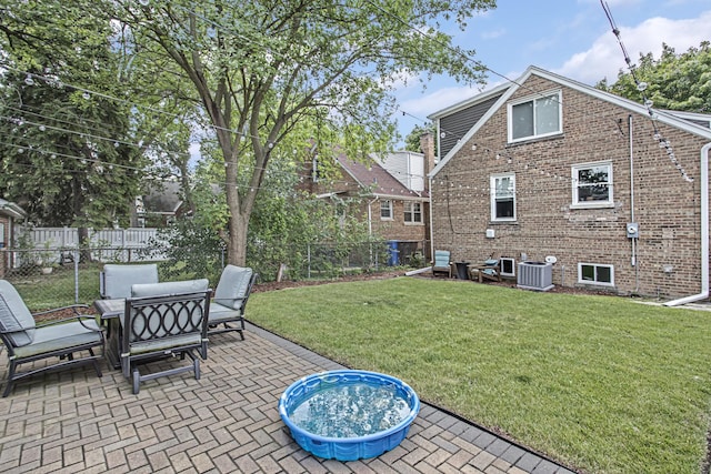 view of yard featuring central AC, a patio, and a fenced backyard