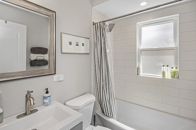 full bath with toilet, shower / bathtub combination with curtain, and vanity