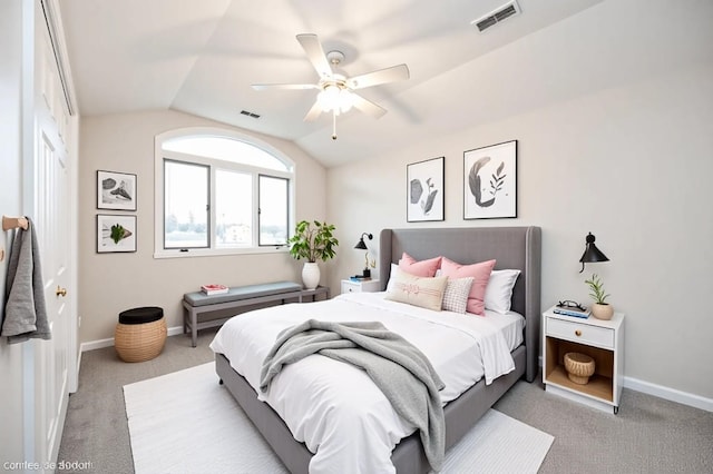 bedroom with visible vents, baseboards, carpet floors, and lofted ceiling