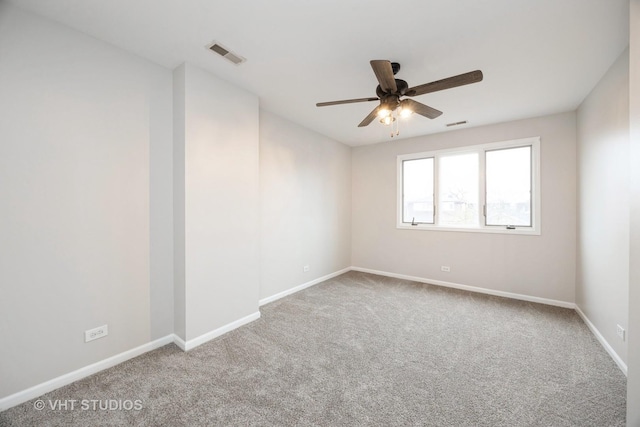 unfurnished room featuring visible vents, baseboards, a ceiling fan, and carpet