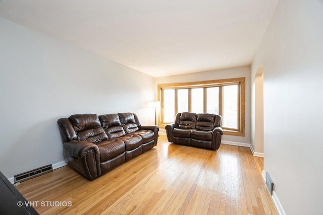 living area featuring light wood finished floors, visible vents, and baseboards