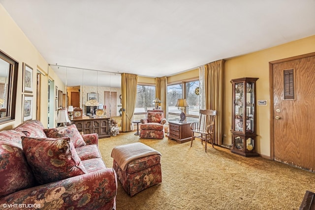 carpeted living area with baseboards