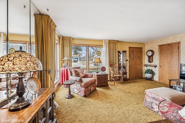 living area featuring plenty of natural light and carpet flooring