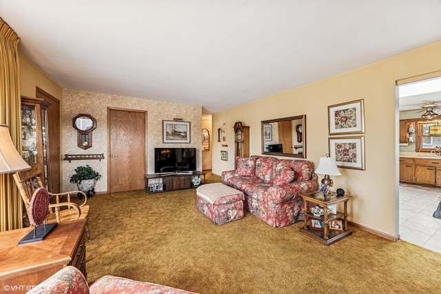 carpeted living area featuring baseboards and a sink