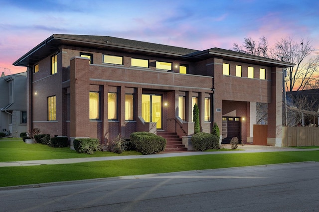 view of front of property with a yard, fence, and brick siding