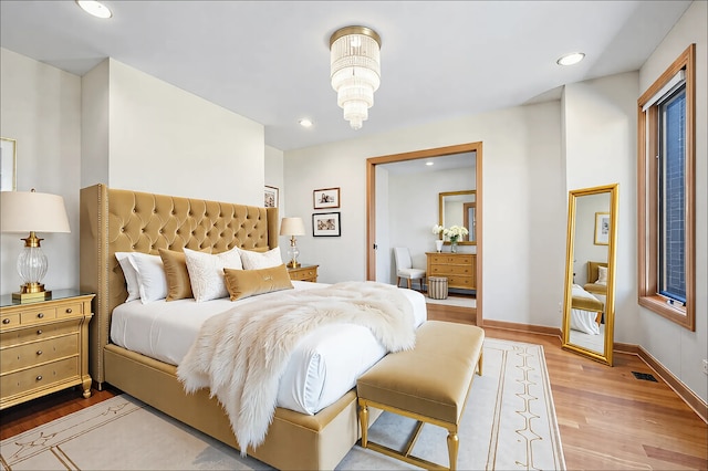 bedroom featuring recessed lighting, visible vents, baseboards, and wood finished floors