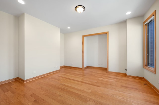 empty room featuring recessed lighting, visible vents, light wood-style flooring, and baseboards