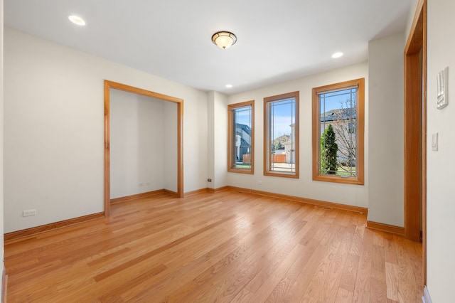 unfurnished bedroom with recessed lighting, light wood-style flooring, and baseboards