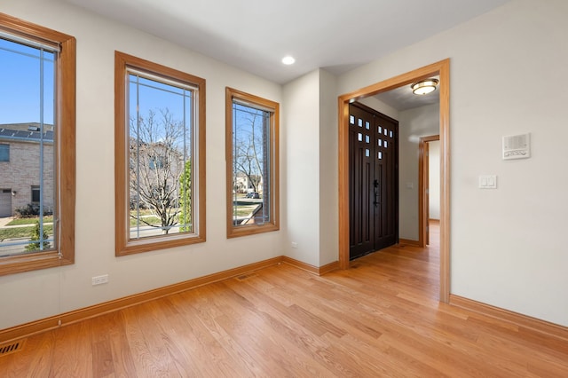 interior space featuring recessed lighting, wood finished floors, and baseboards