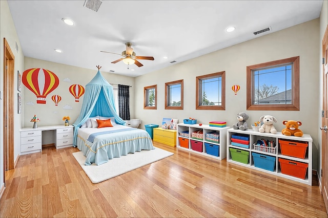 bedroom with recessed lighting, visible vents, light wood finished floors, and built in study area