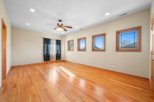 unfurnished room featuring light wood finished floors, baseboards, visible vents, a ceiling fan, and recessed lighting