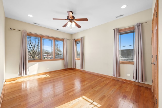 spare room featuring light wood-style floors, visible vents, and recessed lighting