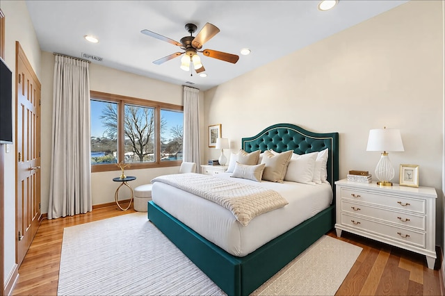 bedroom with ceiling fan, wood finished floors, visible vents, and recessed lighting