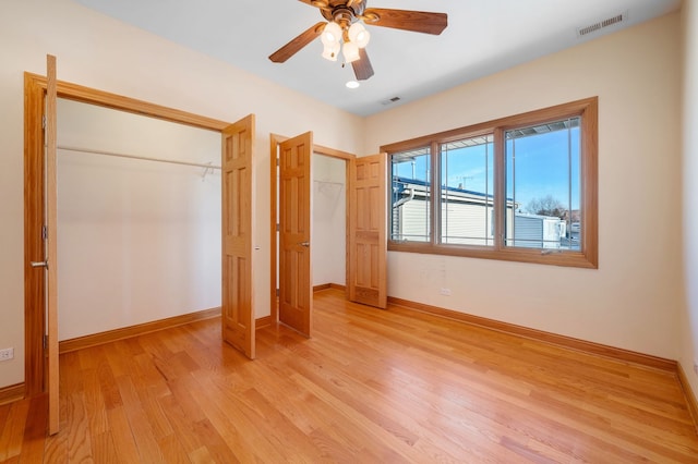 unfurnished bedroom featuring light wood-type flooring, visible vents, and baseboards