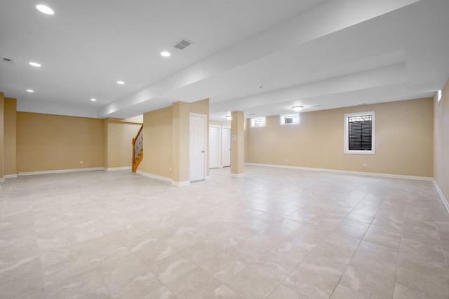 below grade area with baseboards, stairs, visible vents, and recessed lighting