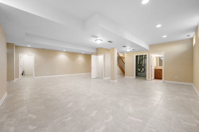 finished basement with stairs, recessed lighting, visible vents, and baseboards