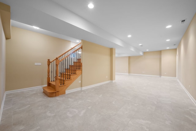 finished basement featuring baseboards, visible vents, and recessed lighting