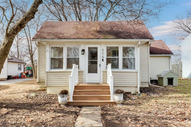 bungalow-style house with roof with shingles