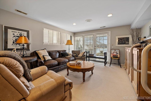 living room featuring light colored carpet, visible vents, and recessed lighting