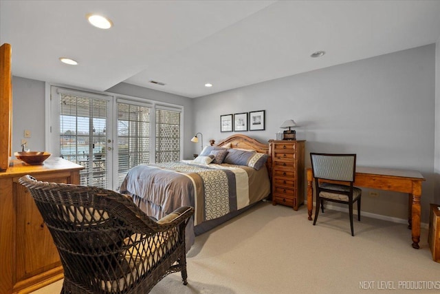 bedroom with light carpet, access to outside, visible vents, and recessed lighting