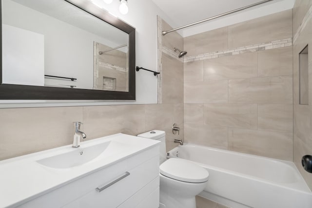 full bathroom featuring shower / bath combination, toilet, tile walls, and vanity