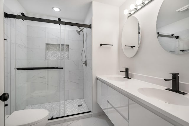 bathroom featuring visible vents, a sink, toilet, and a shower stall