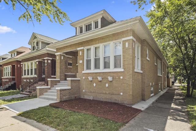 view of front of home with entry steps and brick siding