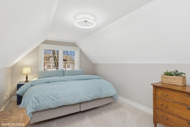 bedroom with lofted ceiling, carpet floors, and baseboards