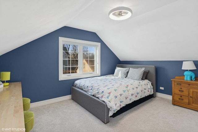 bedroom with carpet, lofted ceiling, and baseboards