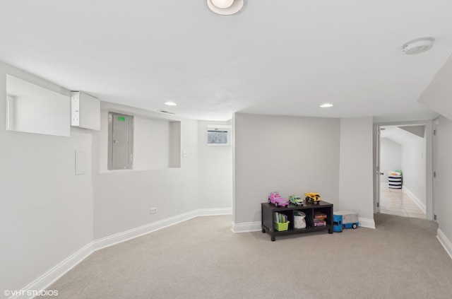 finished basement with recessed lighting, electric panel, light carpet, and baseboards