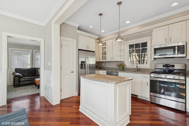 kitchen with stainless steel appliances, ornamental molding, light stone countertops, dark wood finished floors, and glass insert cabinets