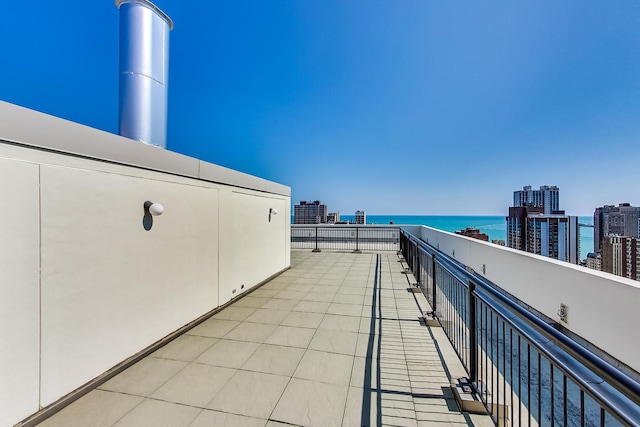 balcony featuring a water view and a city view