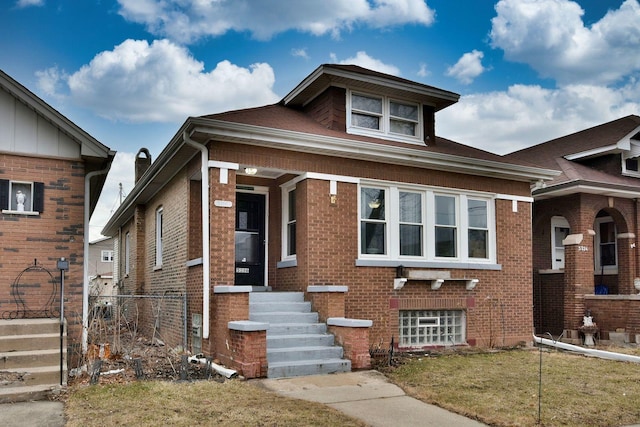 view of front of property with brick siding and fence