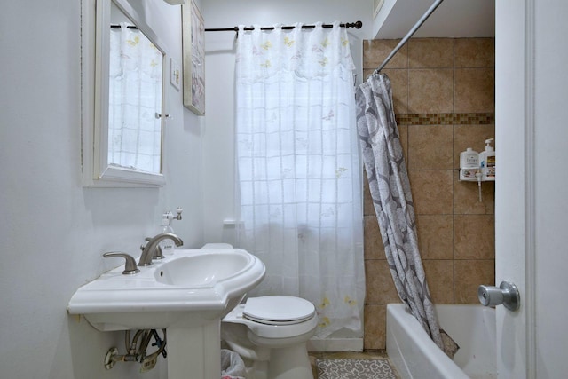 bathroom with shower / bath combination with curtain and toilet