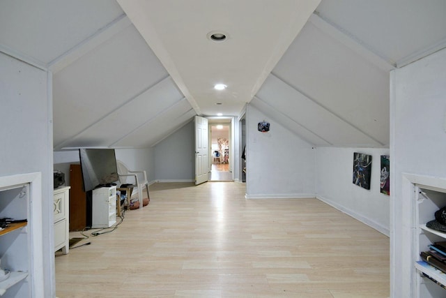 additional living space featuring vaulted ceiling, wood finished floors, and baseboards