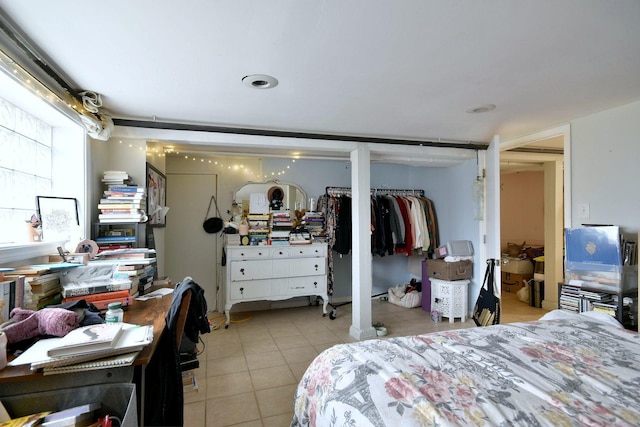 bedroom featuring multiple closets and light tile patterned flooring