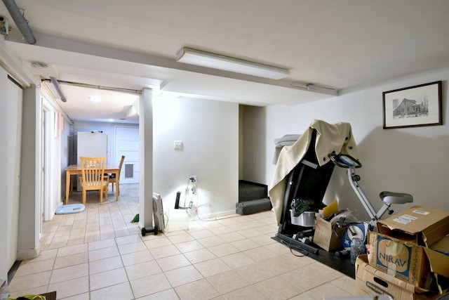 basement with stairs and light tile patterned floors