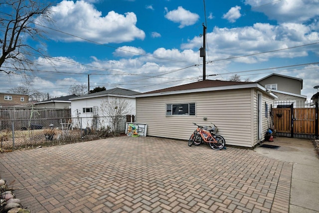 exterior space with a gate, a patio area, and fence