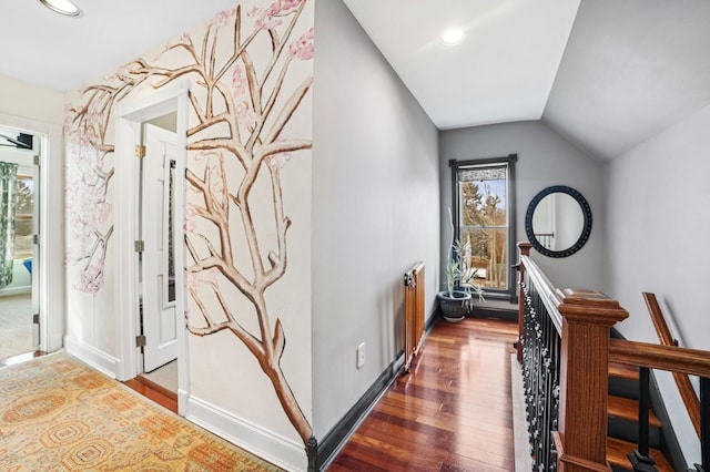 corridor with vaulted ceiling, baseboards, wood finished floors, and recessed lighting