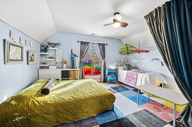 bedroom with a ceiling fan, lofted ceiling, visible vents, and wood finished floors