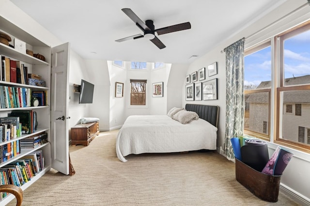 bedroom with carpet, multiple windows, and baseboards