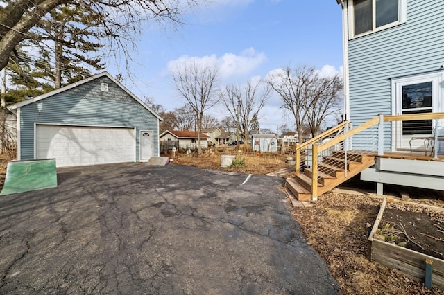 exterior space featuring an outbuilding and a detached garage