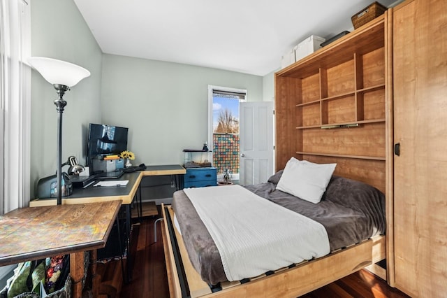 bedroom with dark wood finished floors