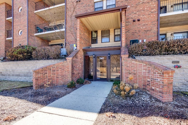 property entrance featuring brick siding