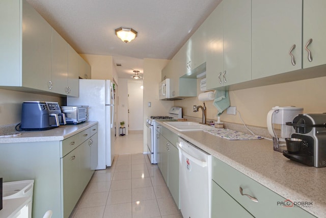 kitchen with white appliances, a toaster, light tile patterned floors, light countertops, and a sink