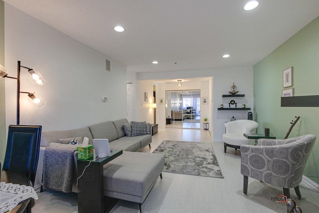 living room featuring recessed lighting and visible vents